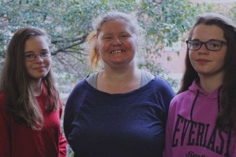 Amanda White with her twin daughters Lilly and Beth, who are 14 years old.