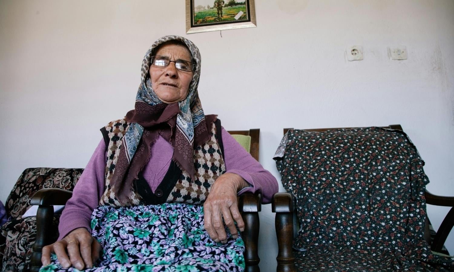 elderly women with headscarf sitting on a sofa aged care