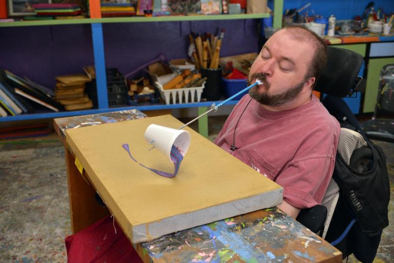 An artist performing blowing art