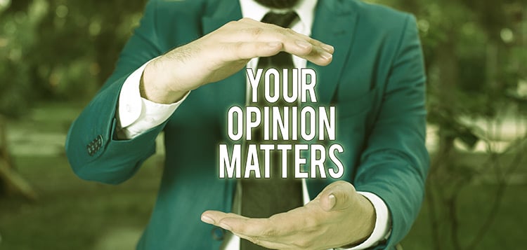 Man holding text that reads your opinion matters