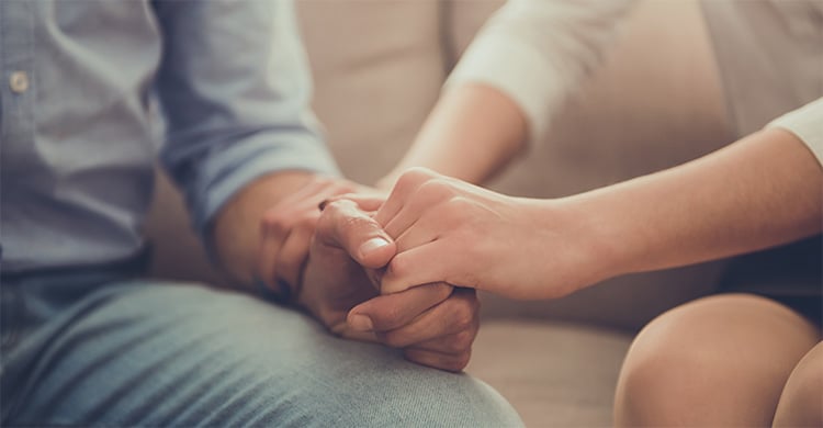 holding hands for support