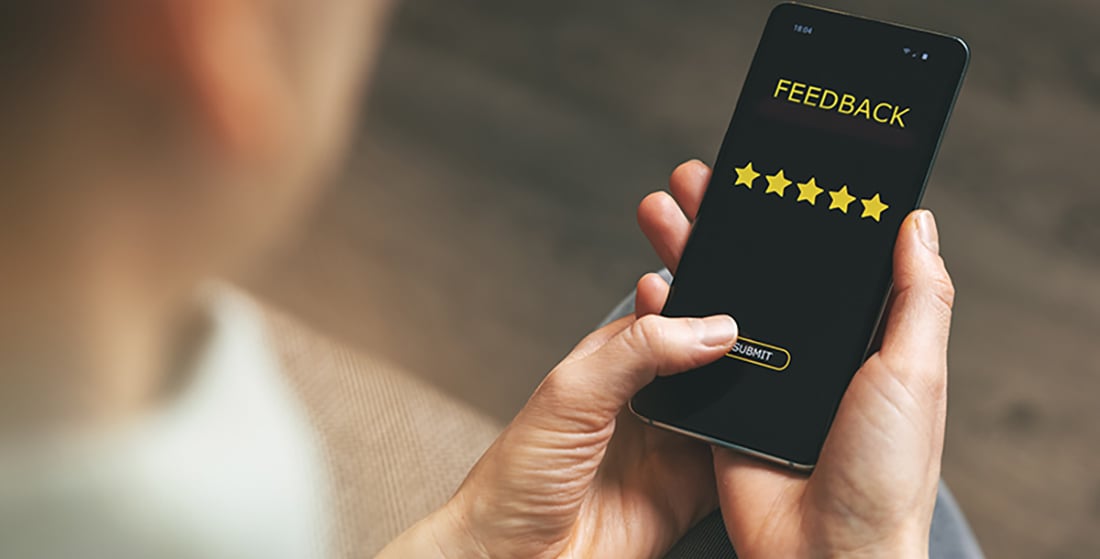 person holding phne and clicking on submit for a 5 star review