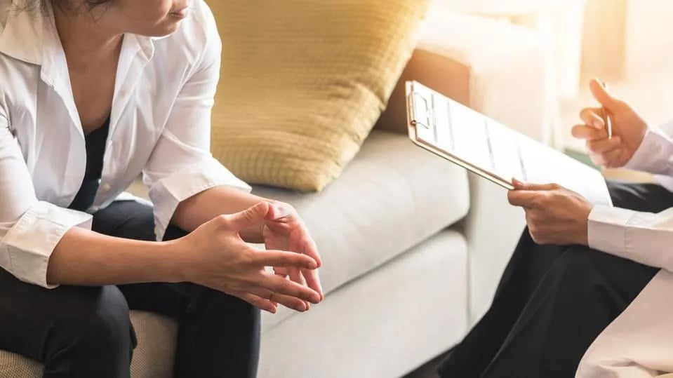 Two people sitting in front of each other during a counselling session