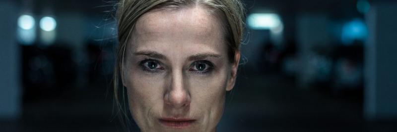 closeup of a woman's face, which shows a solemn expression